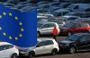 A worker poses as he walks between second hand cars at the Auto1.com company grounds in Zoerbig