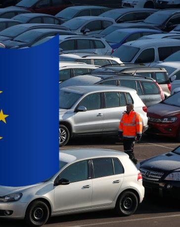 A worker poses as he walks between second hand cars at the Auto1.com company grounds in Zoerbig
