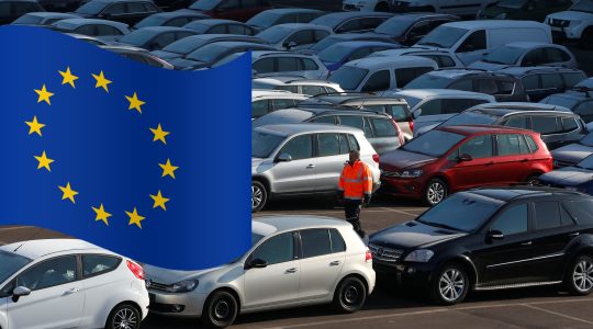 A worker poses as he walks between second hand cars at the Auto1.com company grounds in Zoerbig