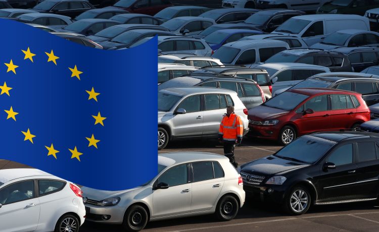 A worker poses as he walks between second hand cars at the Auto1.com company grounds in Zoerbig