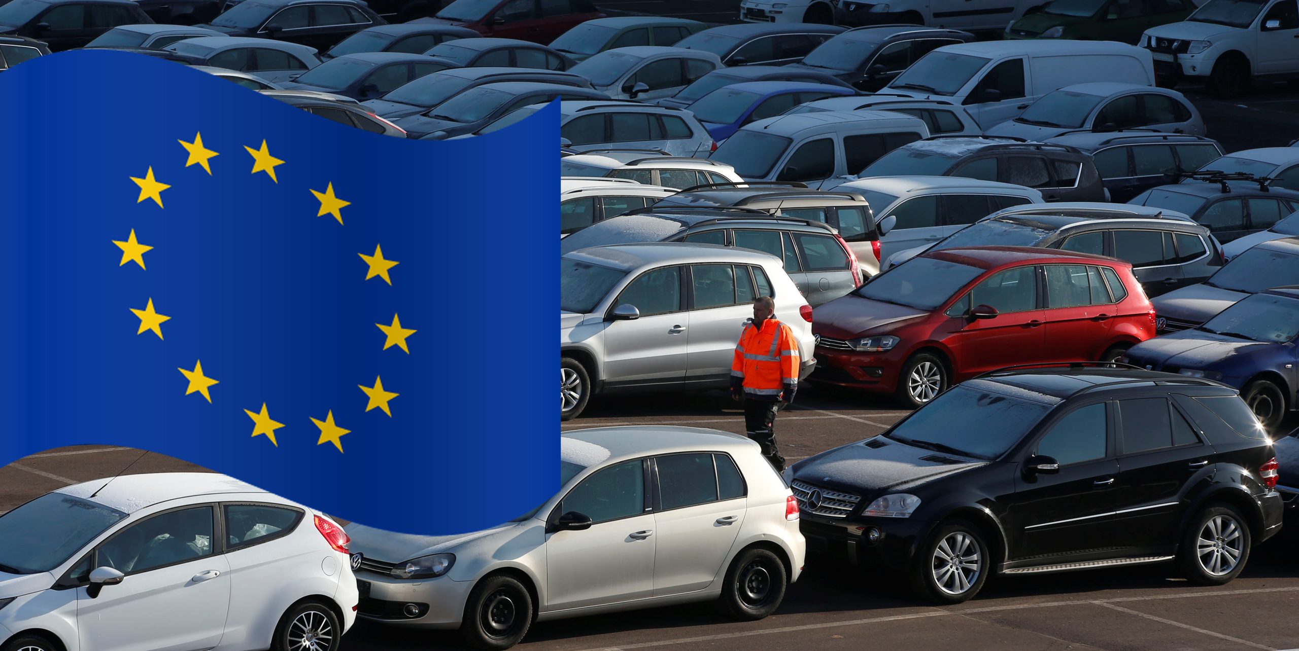 A worker poses as he walks between second hand cars at the Auto1.com company grounds in Zoerbig